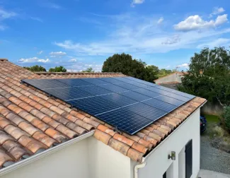 Solar installer on roof installing solar panels 